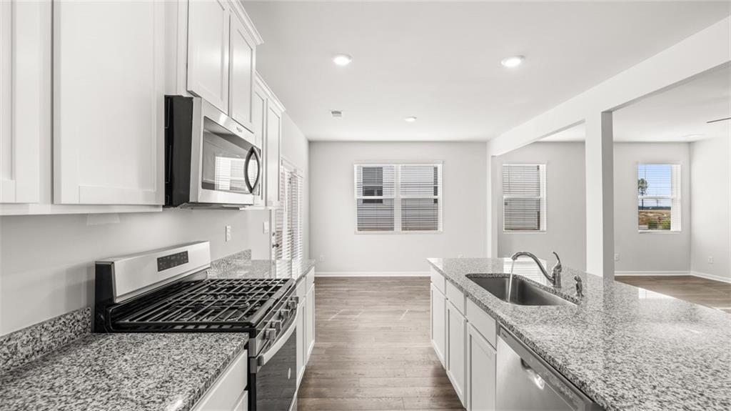 177 Lauritsen Way Newnan, GA 30265 - Photo 8 of 37 a kitchen that has a sink a stove and cabinets