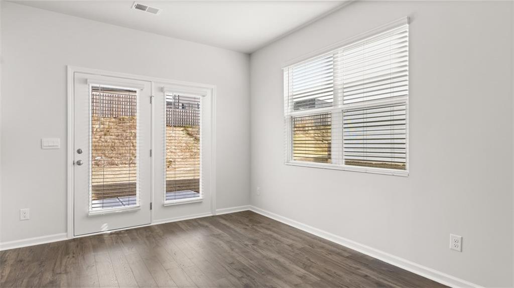 177 Lauritsen Way Newnan, GA 30265 - Photo 10 of 37 a view of wooden floor and windows in a room