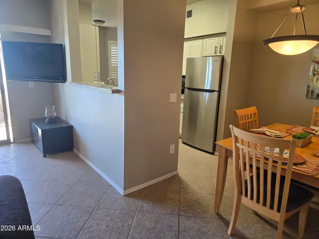 a view of kitchen with furniture and refrigerator