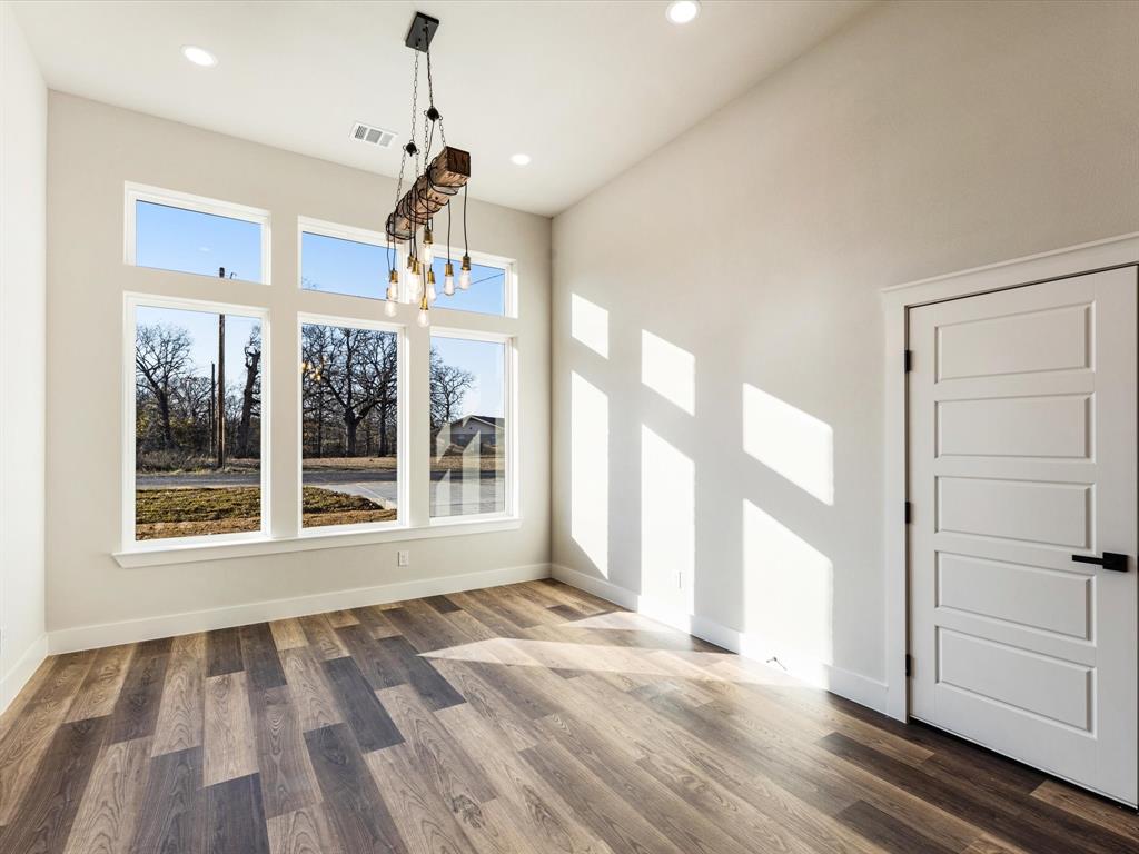 5018 Point La Vista Road Malakoff, TX 75148 - Photo 13 of 32 Unfurnished dining area with wood finished floors and a chandelier