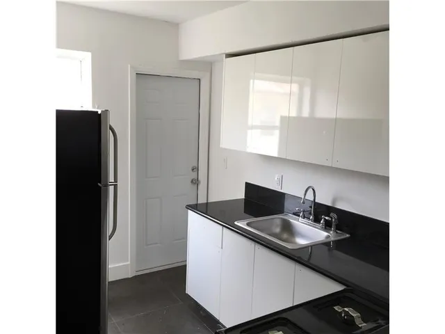 a close view of sink and refrigerator