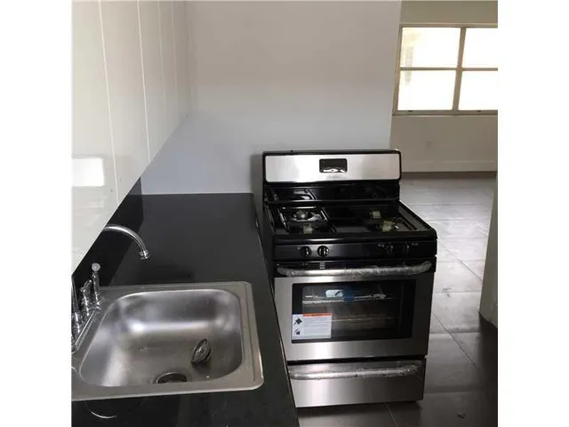 a close view of water heater and wooden cabinets