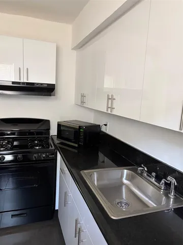 a kitchen with a sink and cabinets