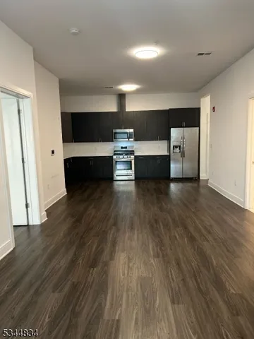 a view of living room with furniture and wooden floor