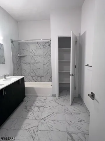 a bathroom with a bathtub and shower