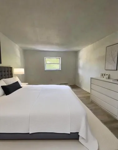 a bedroom with a bed and a night stand