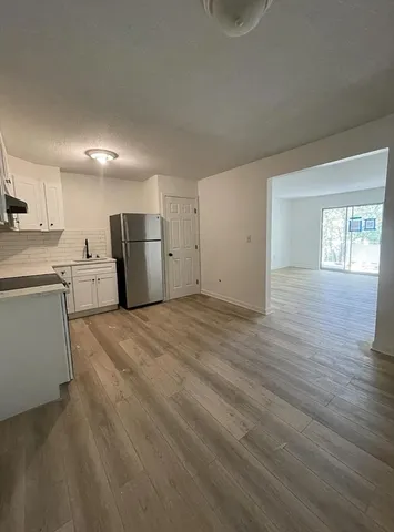 a view of a kitchen with a sink dishwasher and a refrigerator