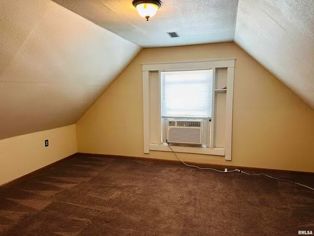 an empty room with a empty space and windows