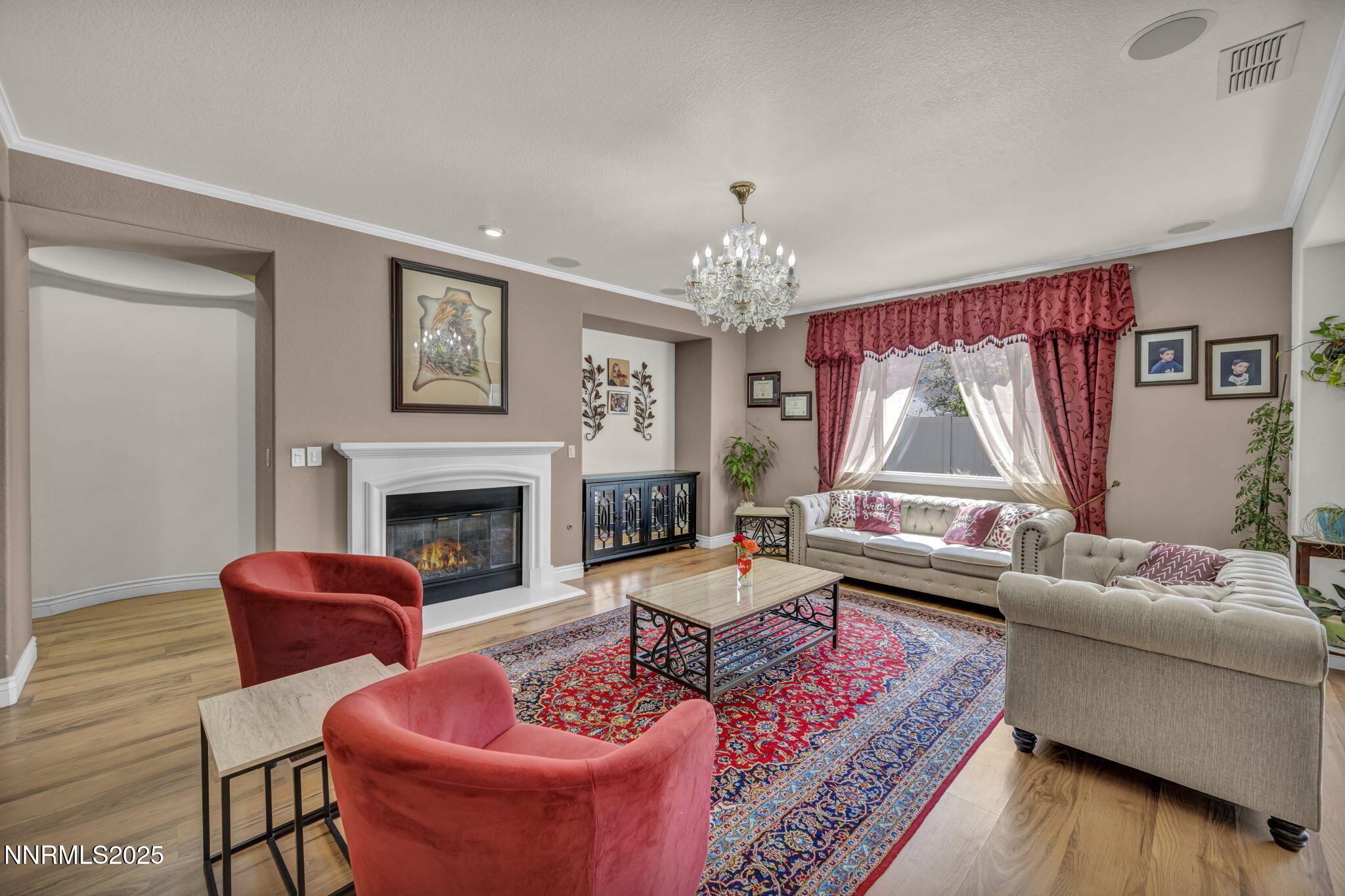 10598 Fort Morgan Way Reno, NV 89521 - Photo 5 of 62 a living room with furniture a fireplace and a chandelier