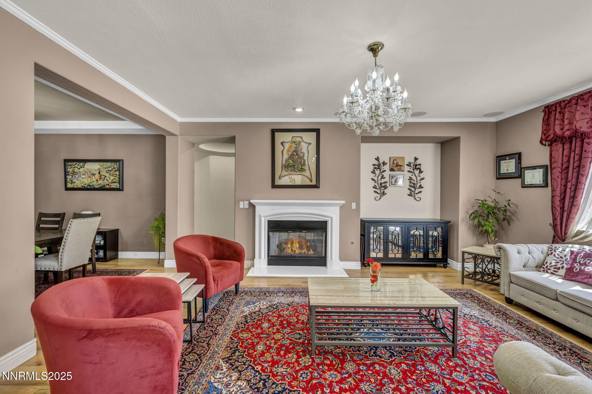 10598 Fort Morgan Way Reno, NV 89521 - Photo 8 of 62 a living room with furniture a chandelier and a fireplace