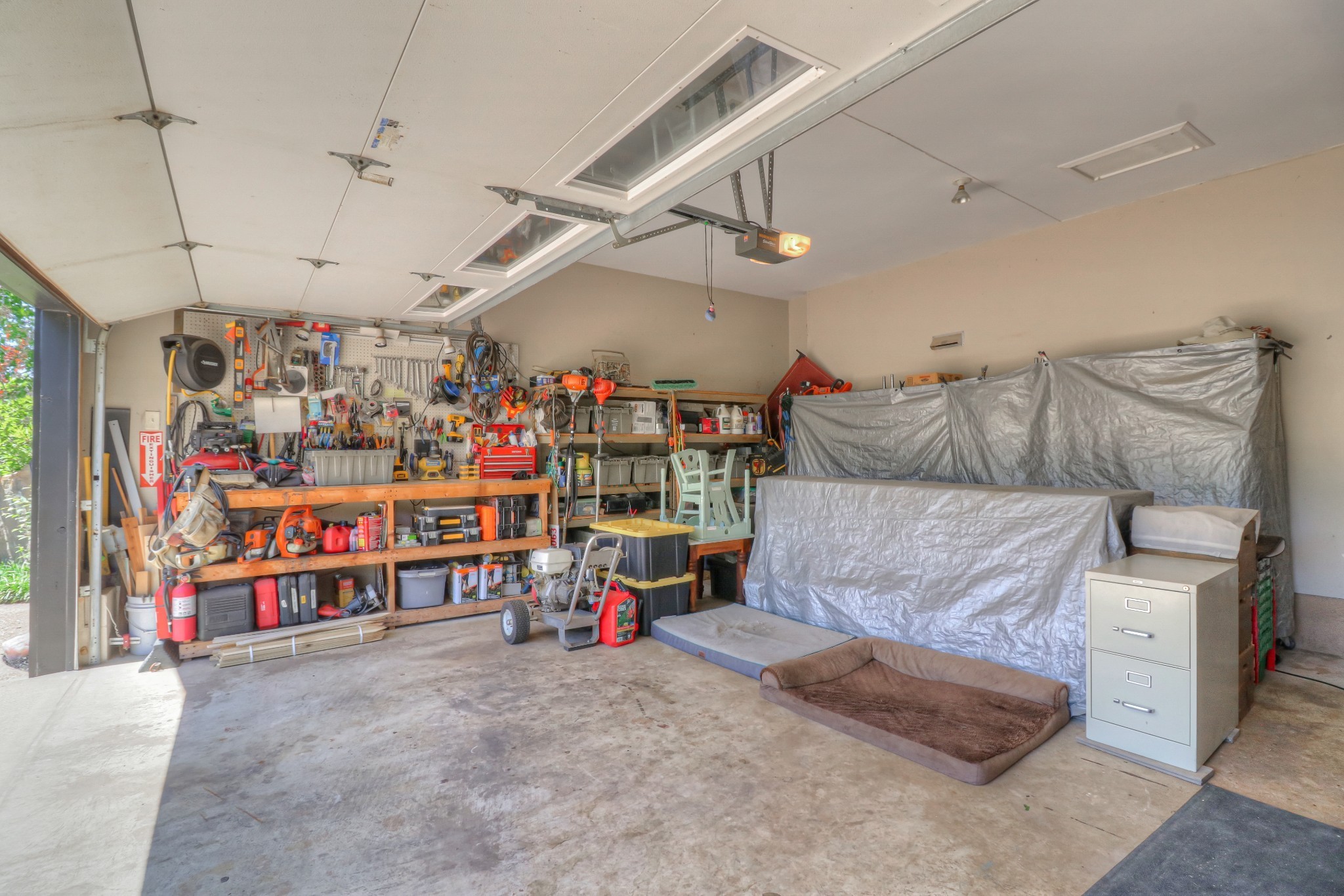 7308 Walker Road Fairview, TN 37062 - Photo 30 of 36 a garage with a white cabinets and couches with wooden floor
