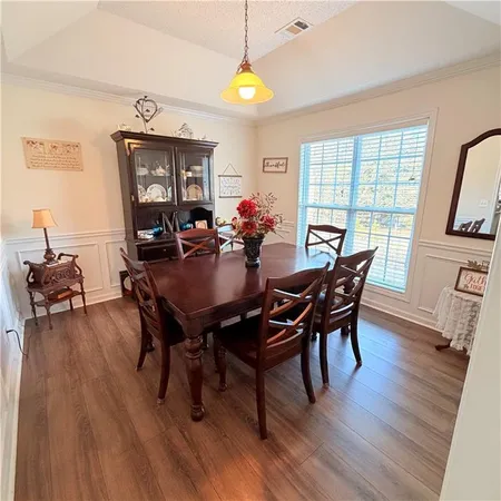 a view of a dining room with furniture and wooden floor