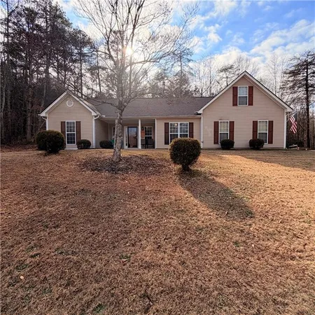 a front view of house with yard and trees
