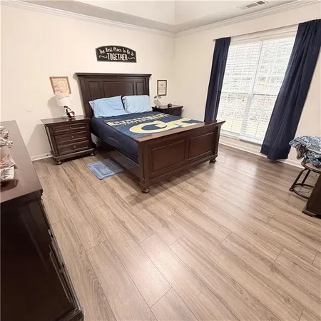 a view of bedroom with furniture and wooden floor