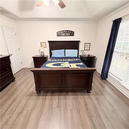 a bedroom with a bed and wooden floor