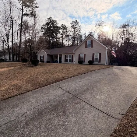 a front view of house with yard and trees