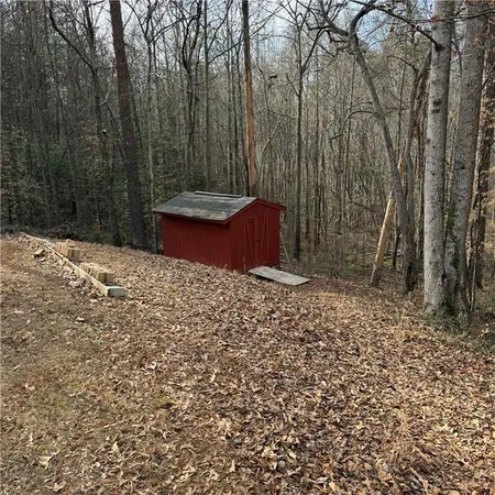 a view of house with backyard and trees