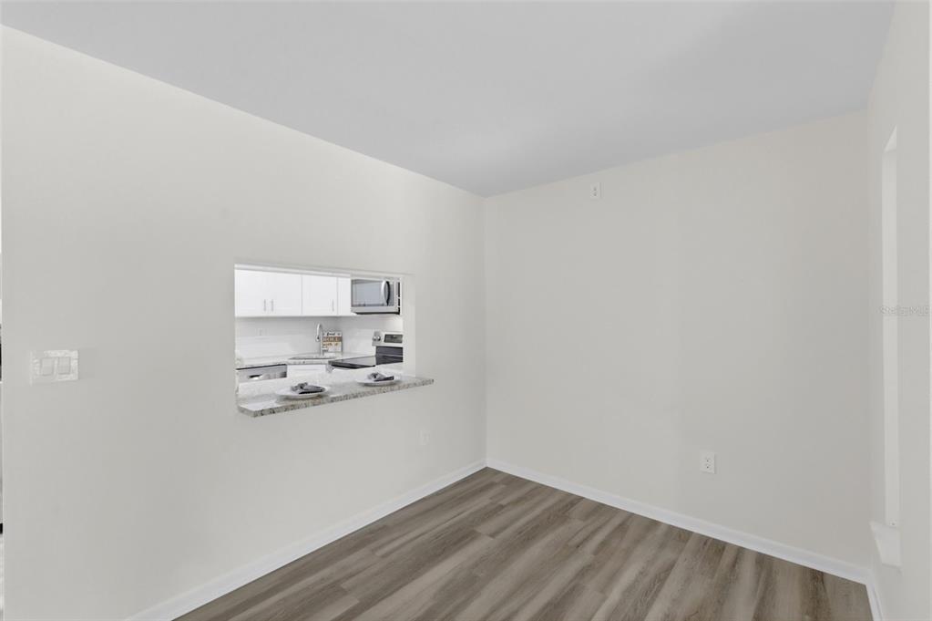 1135 Pine Ridge Circle West, Unit A2 Tarpon Springs, FL 34688 - Photo 12 of 63 a view of kitchen and wooden floor