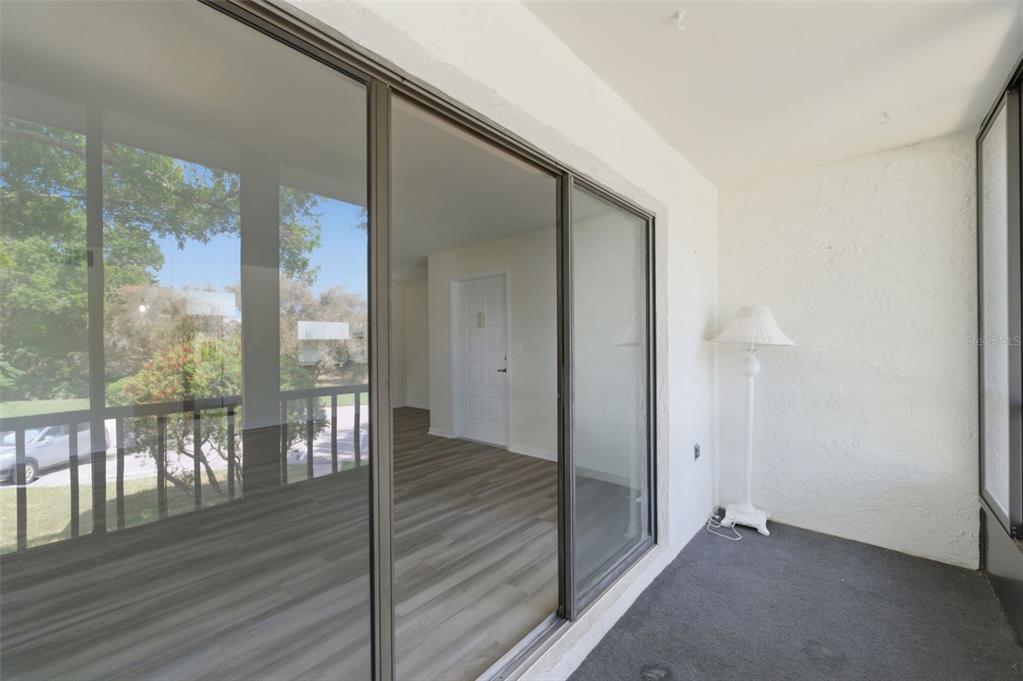 1135 Pine Ridge Circle West, Unit A2 Tarpon Springs, FL 34688 - Photo 20 of 63 a view of a room with wooden floor and windows