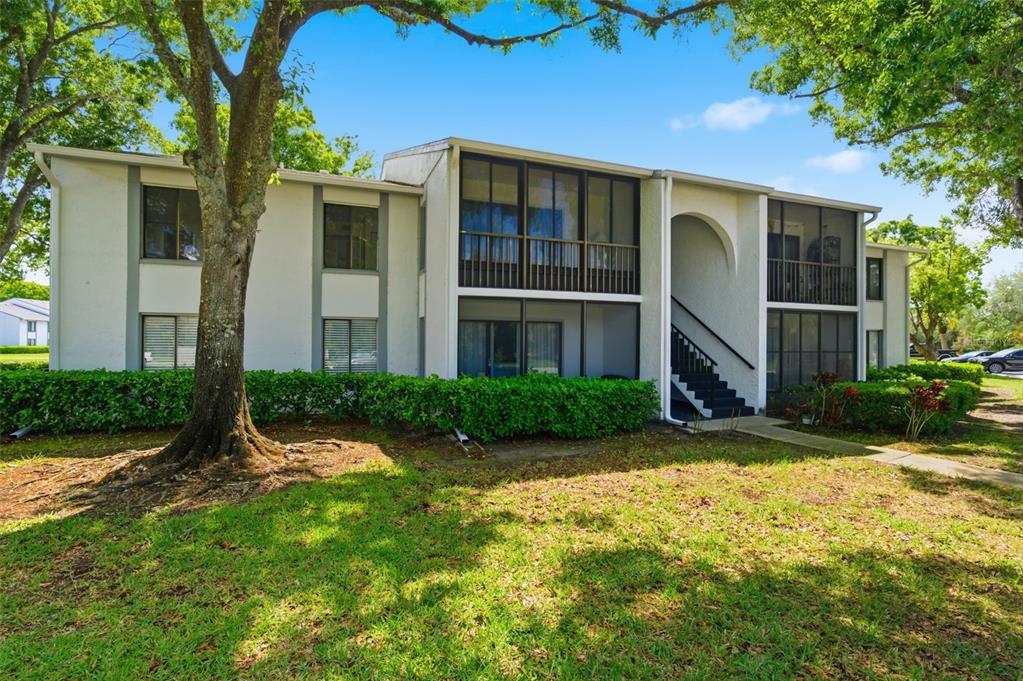 1135 Pine Ridge Circle West, Unit A2 Tarpon Springs, FL 34688 - Photo 2 of 63 a view of a house with a yard and large tree
