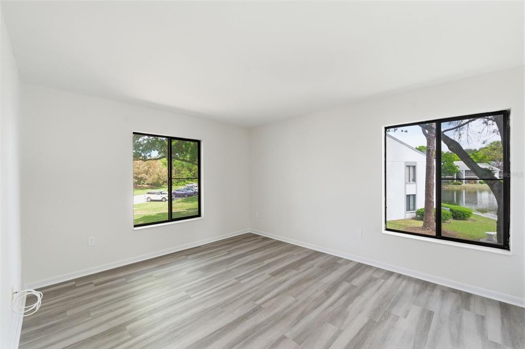 1135 Pine Ridge Circle West, Unit A2 Tarpon Springs, FL 34688 - Photo 23 of 63 an empty room with windows