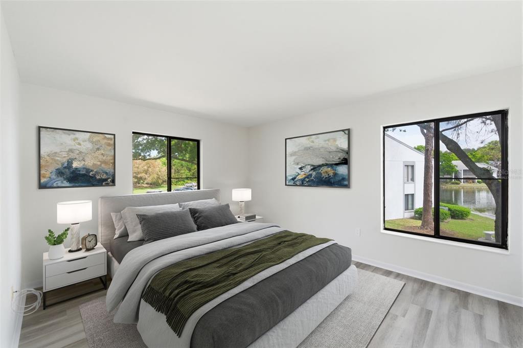 1135 Pine Ridge Circle West, Unit A2 Tarpon Springs, FL 34688 - Photo 24 of 63 a bedroom with a bed and a painting on the wall