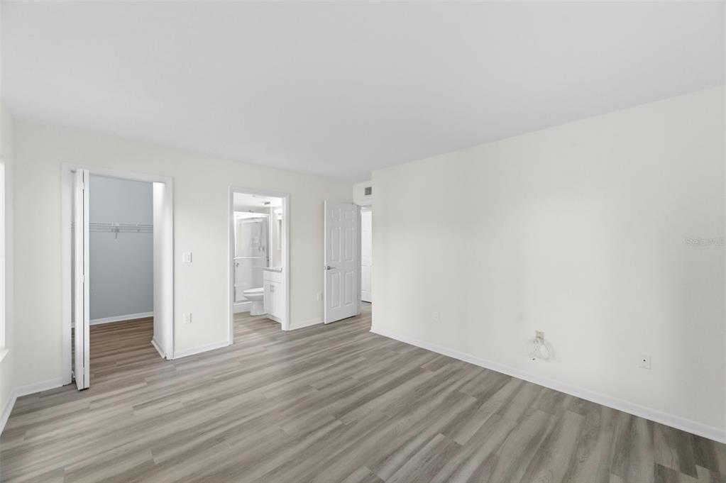 1135 Pine Ridge Circle West, Unit A2 Tarpon Springs, FL 34688 - Photo 26 of 63 a view of an empty room and wooden floor