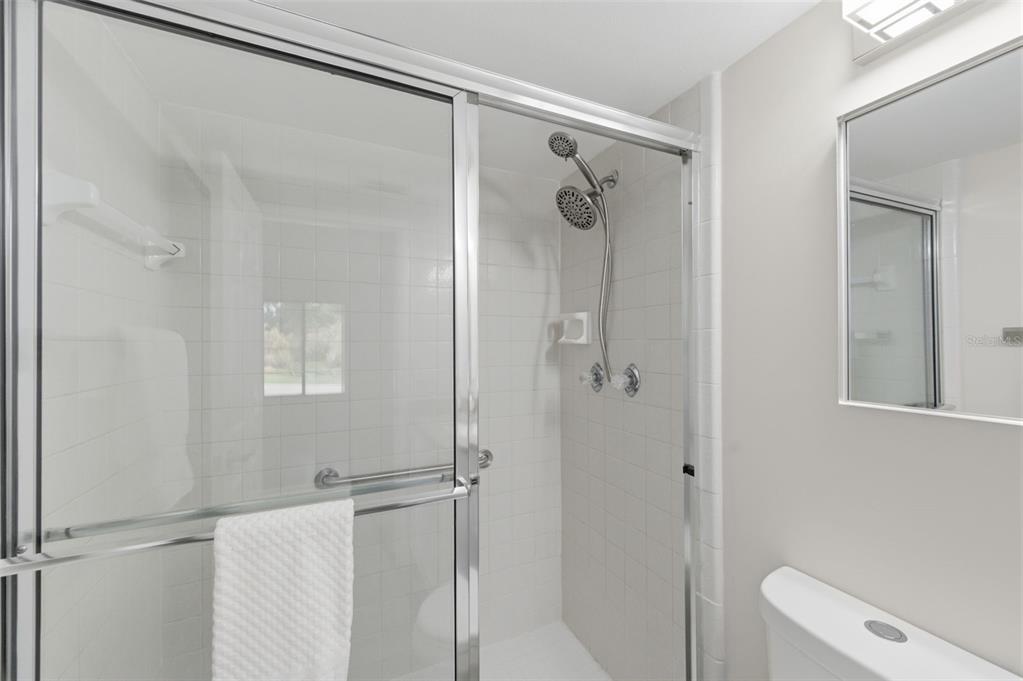 1135 Pine Ridge Circle West, Unit A2 Tarpon Springs, FL 34688 - Photo 30 of 63 a bathroom with a shower and a toilet