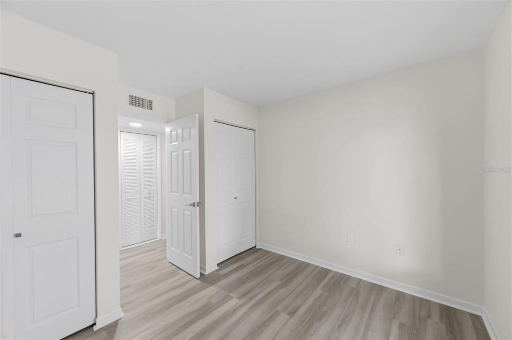 1135 Pine Ridge Circle West, Unit A2 Tarpon Springs, FL 34688 - Photo 33 of 63 a view of an empty room with wooden floor and a window
