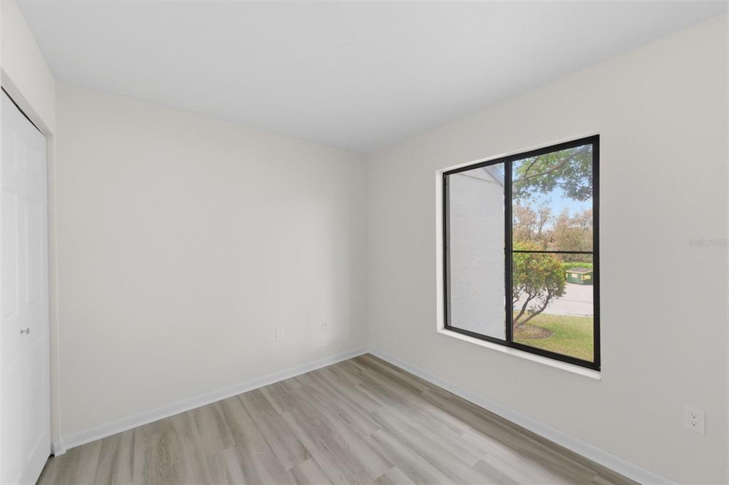 1135 Pine Ridge Circle West, Unit A2 Tarpon Springs, FL 34688 - Photo 34 of 63 an empty room with a window