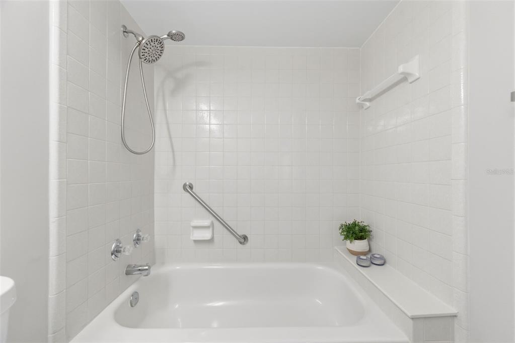 1135 Pine Ridge Circle West, Unit A2 Tarpon Springs, FL 34688 - Photo 36 of 63 a bathroom with a tub