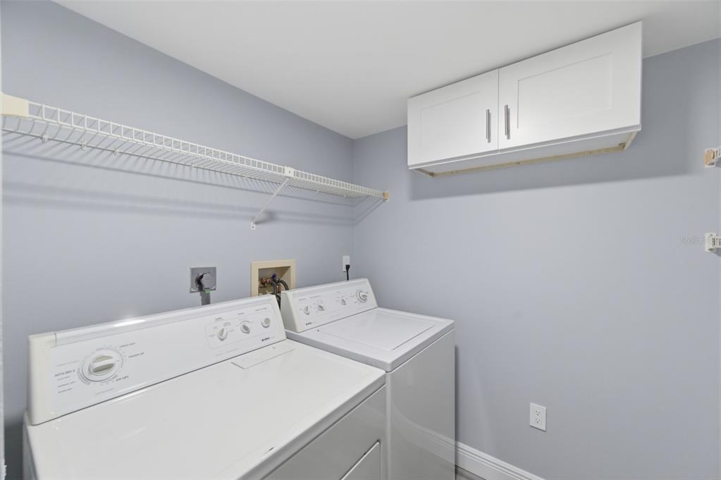 1135 Pine Ridge Circle West, Unit A2 Tarpon Springs, FL 34688 - Photo 37 of 63 a utility room with dryer and washer