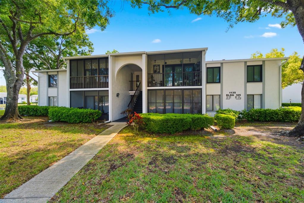 1135 Pine Ridge Circle West, Unit A2 Tarpon Springs, FL 34688 - Photo 4 of 63 a view of a house with a yard