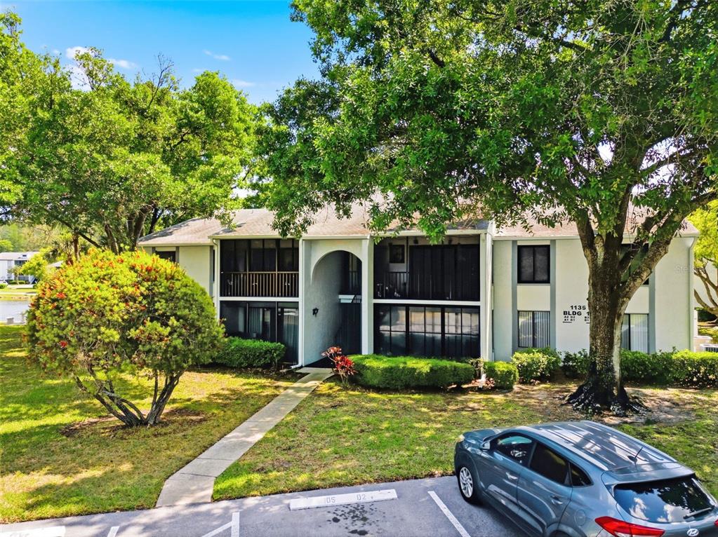 1135 Pine Ridge Circle West, Unit A2 Tarpon Springs, FL 34688 - Photo 44 of 63 front view of house with a yard