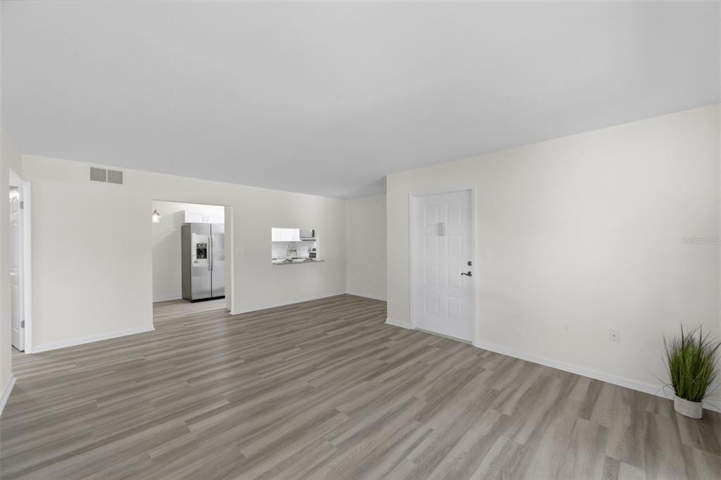 1135 Pine Ridge Circle West, Unit A2 Tarpon Springs, FL 34688 - Photo 6 of 63 a view of wooden floor and a sink in a room