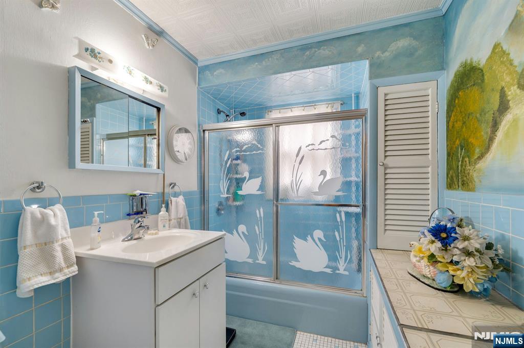 79 Washington Street Harrison, NJ 07029 - Photo 14 of 25 a bathroom with a sink mirror and vanity