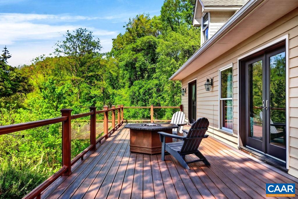 1059 Bryant Mountain Road Roseland, VA 22967 - Photo 40 of 58 a balcony with furniture and wooden floor