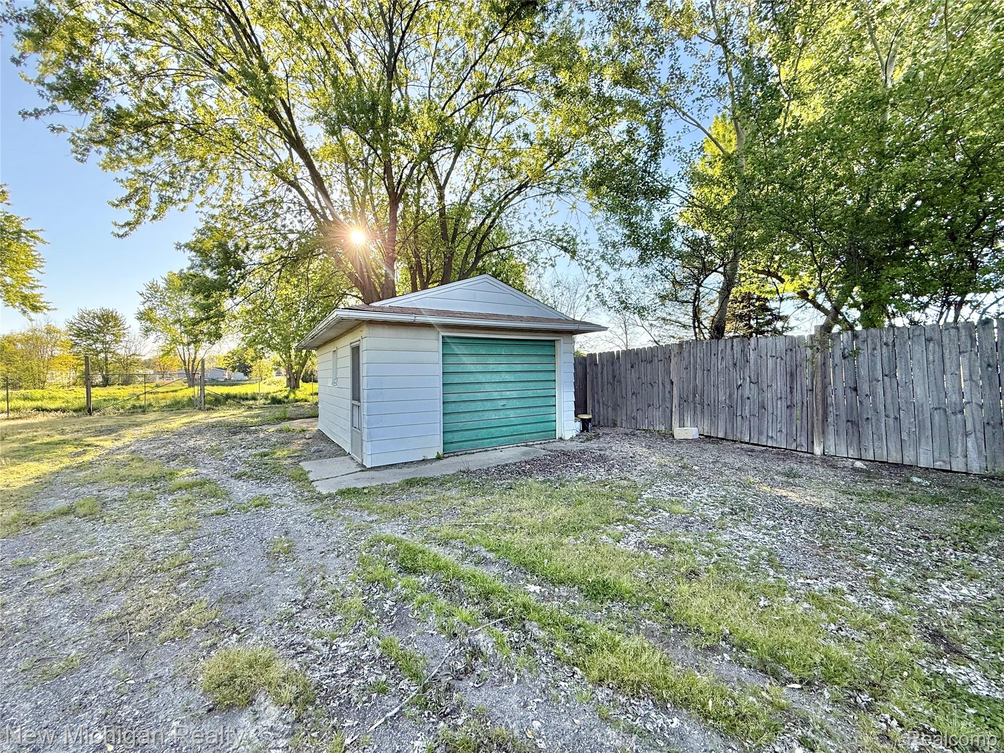 5288 Torrey Road Flint, MI 48507 - Photo 32 of 41 Fenced backyard featuring an outbuilding and a garage