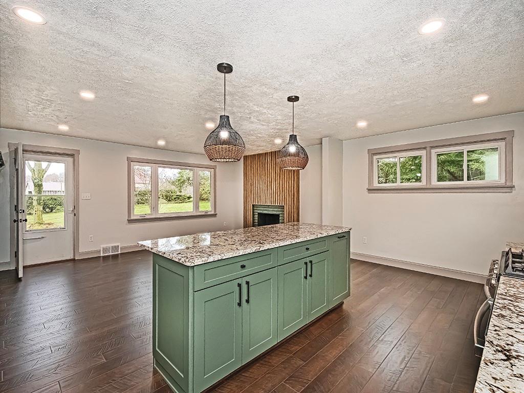 3040 Dutch Ridge Road Beaver, PA 15009 - Photo 12 of 30 a kitchen with kitchen island stainless steel appliances a sink stove and wooden floor