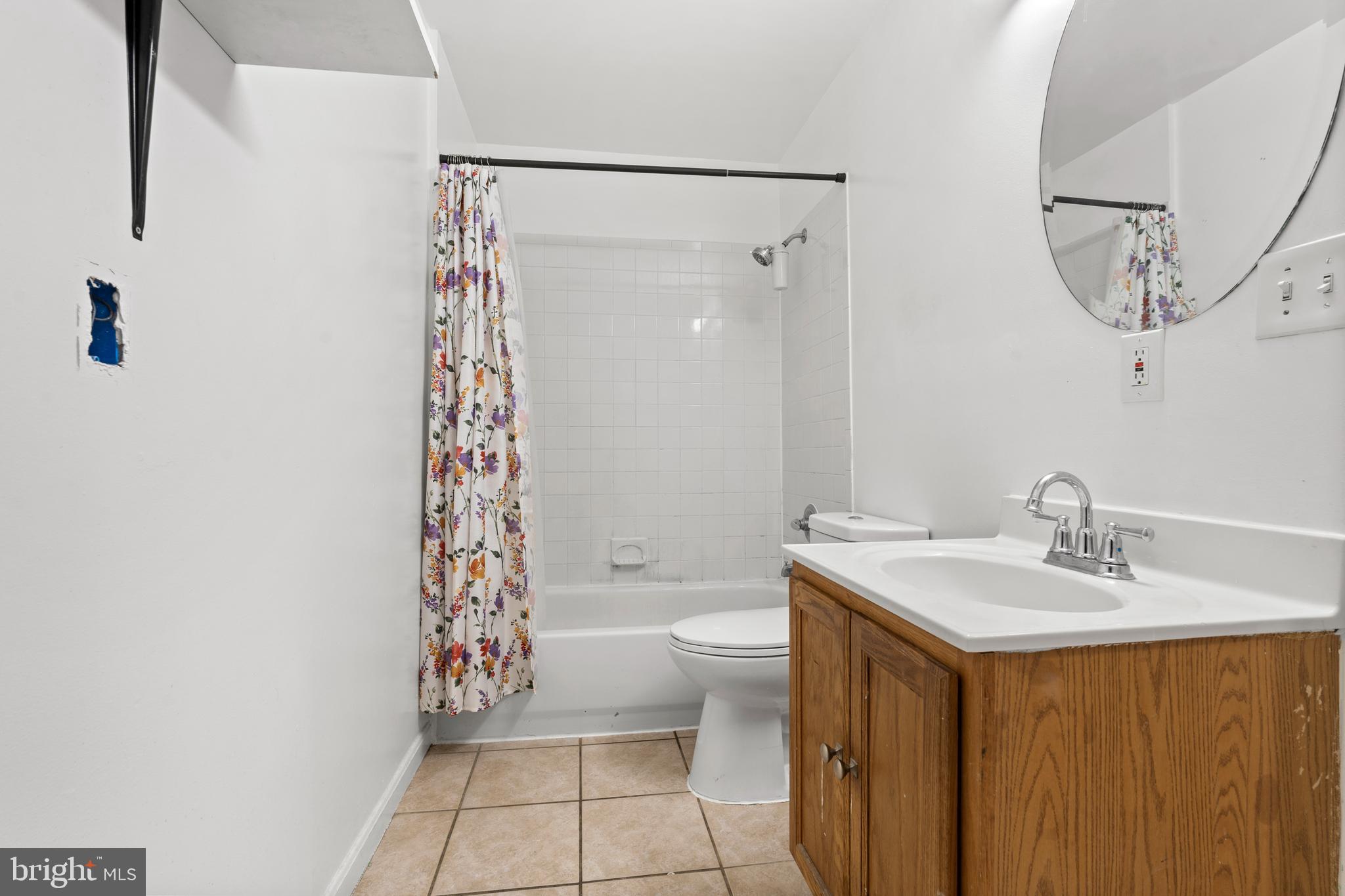 4203 Shell Street Capitol Heights, MD 20743 - Photo 11 of 25 a bathroom with a sink a toilet and shower curtain