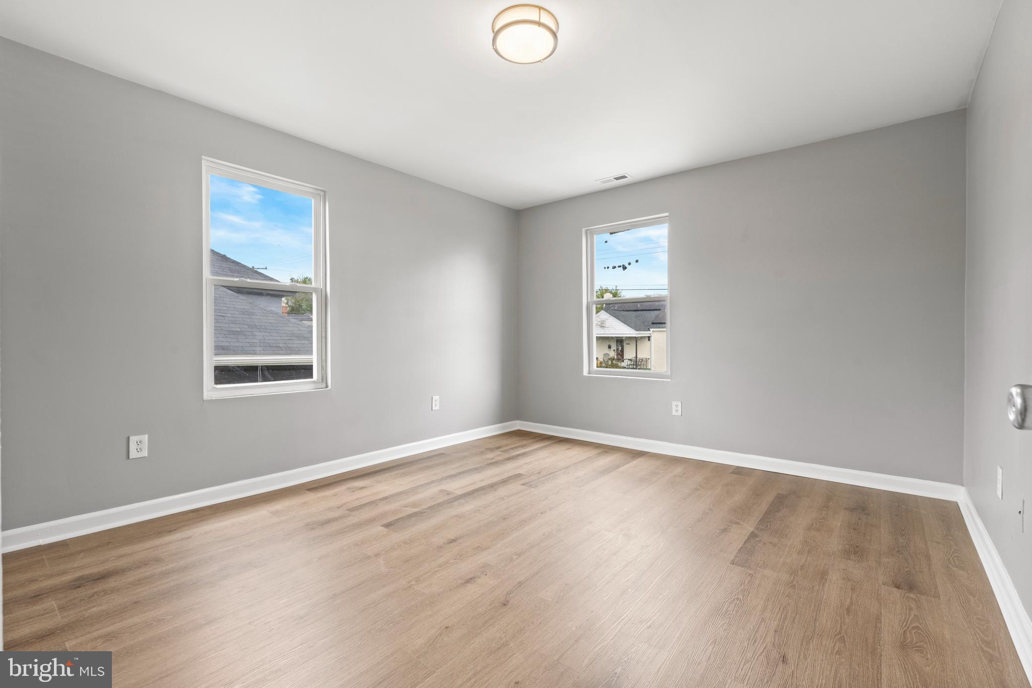 4203 Shell Street Capitol Heights, MD 20743 - Photo 13 of 25 a view of an empty room with wooden floor and a window