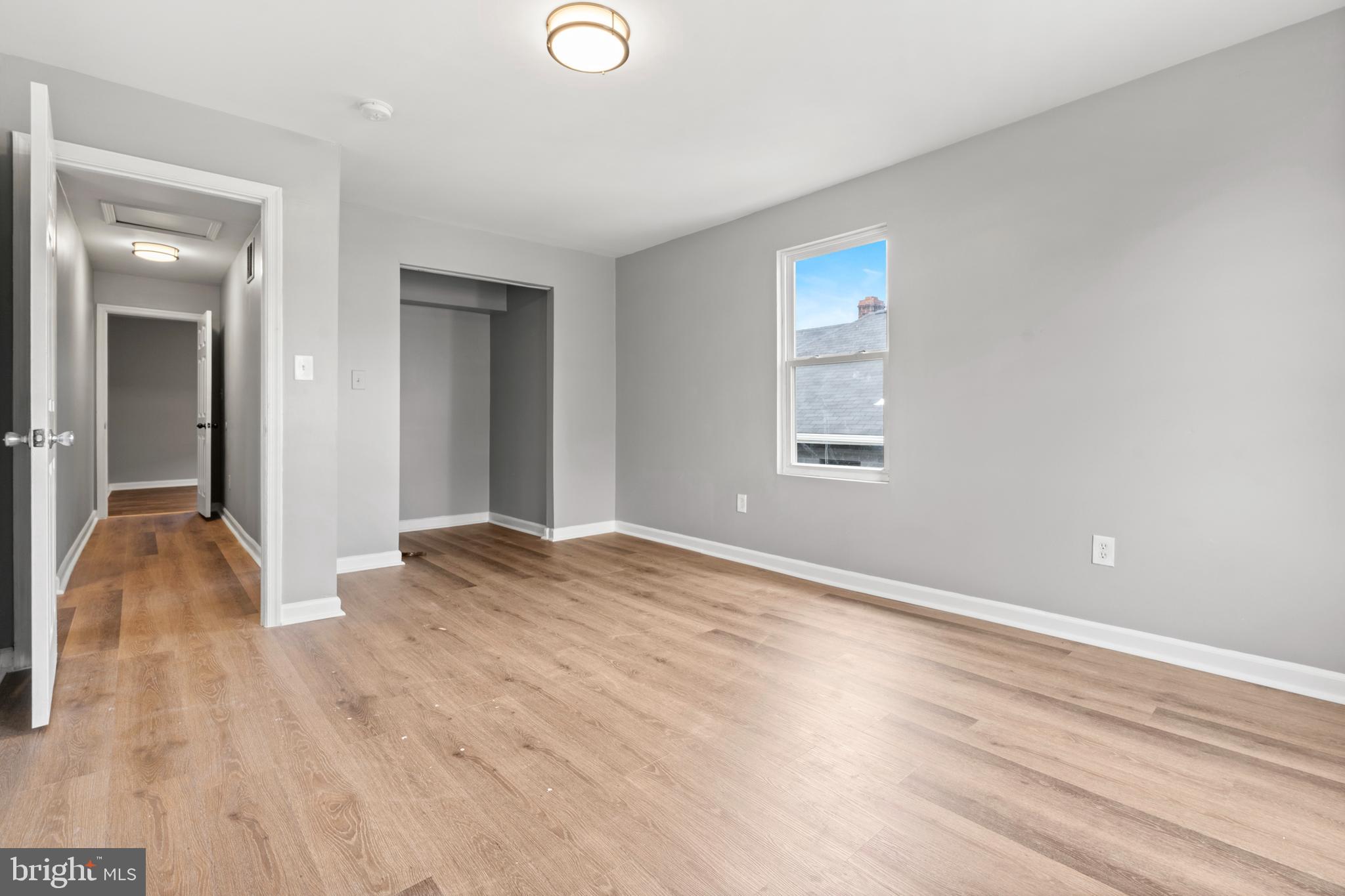 4203 Shell Street Capitol Heights, MD 20743 - Photo 14 of 25 an empty room with wooden floor and windows