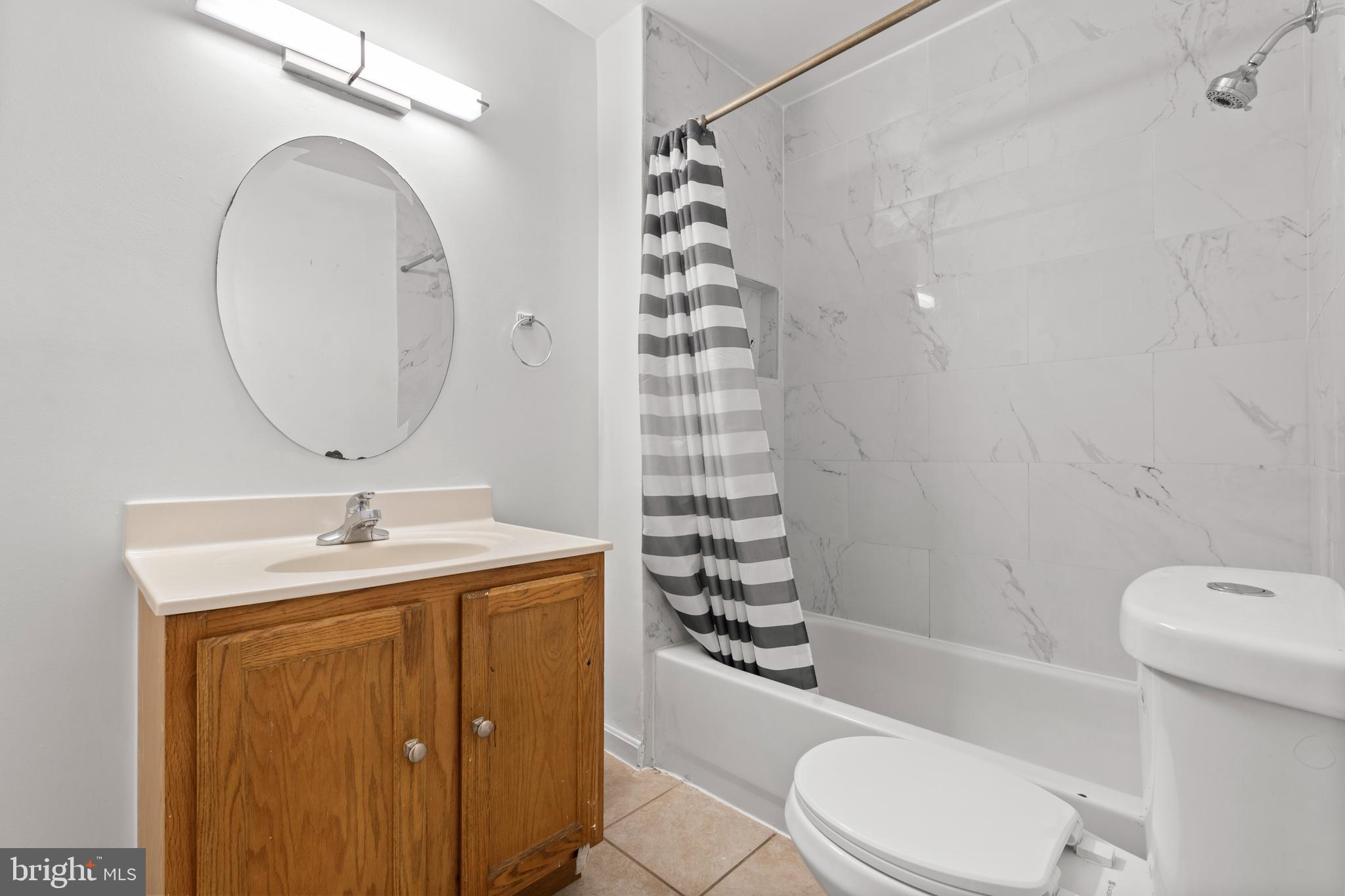 4203 Shell Street Capitol Heights, MD 20743 - Photo 19 of 25 a bathroom with a sink a toilet and shower