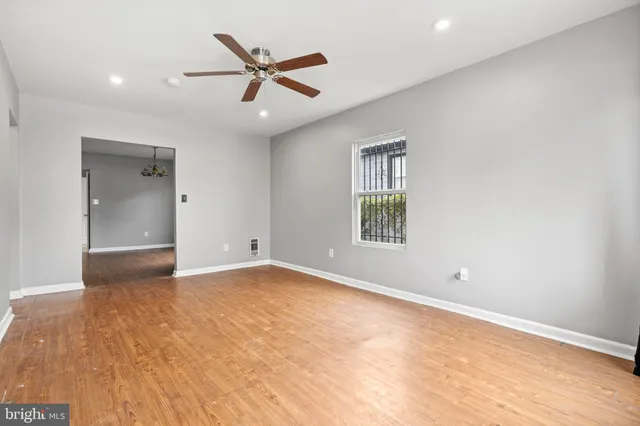 an empty room with closet and windows