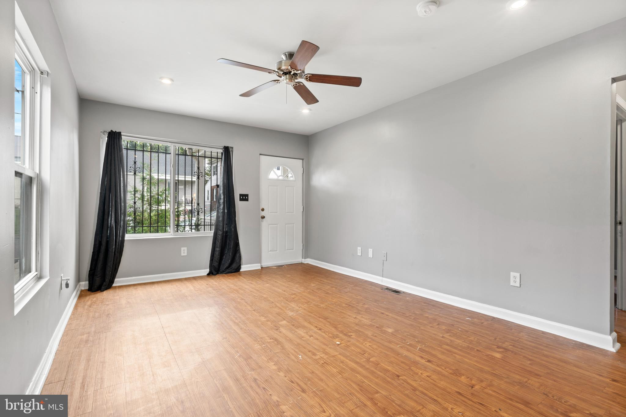4203 Shell Street Capitol Heights, MD 20743 - Photo 4 of 25 a view of a livingroom with a ceiling fan & windows