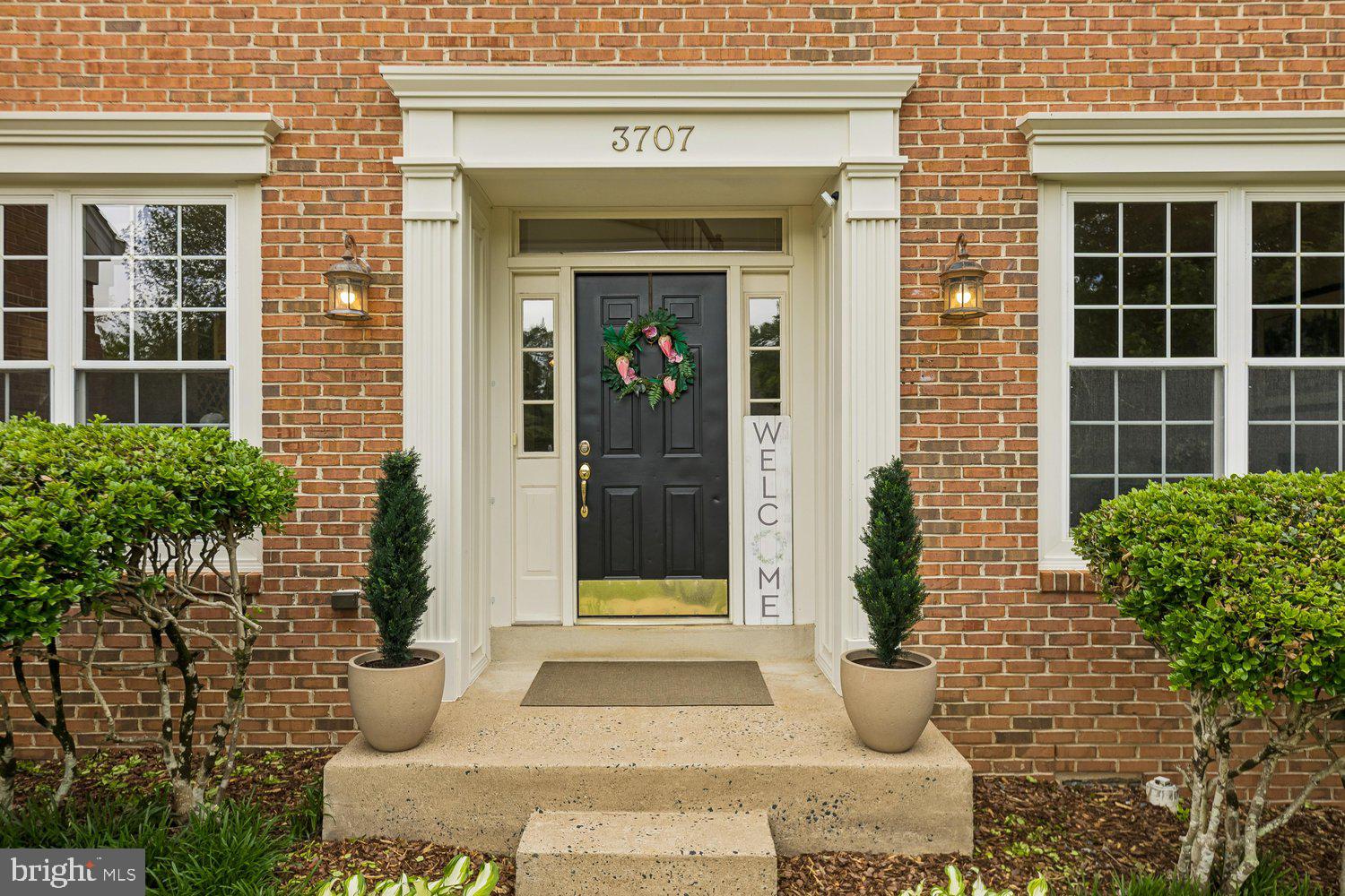 3707 Turn Back Trail Triangle, VA 22172 - Photo 2 of 55 a view of a brick house with potted plants