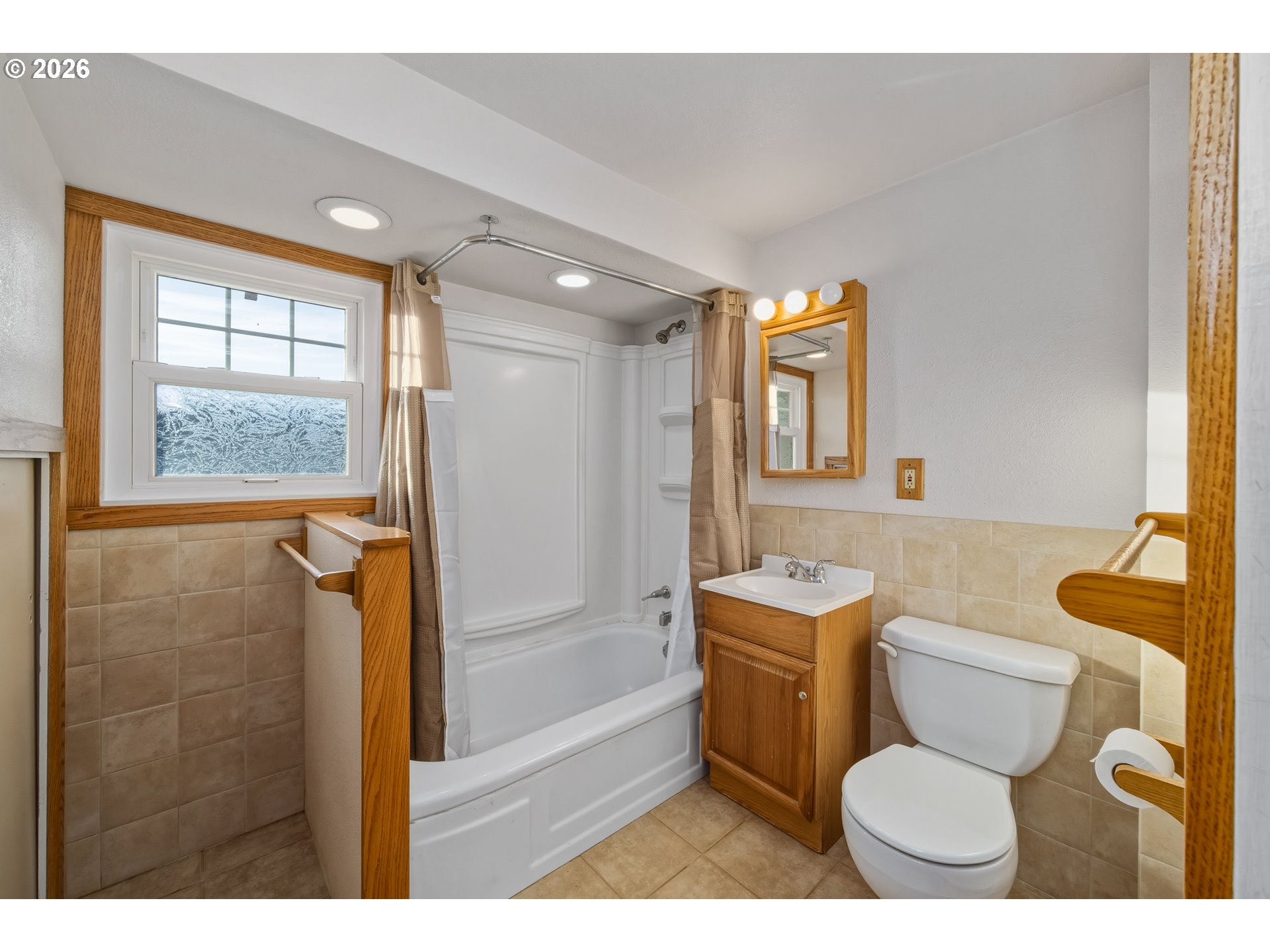 2507 6th Street Tillamook, OR 97141 - Photo 25 of 45 a bathroom with a toilet sink and mirror