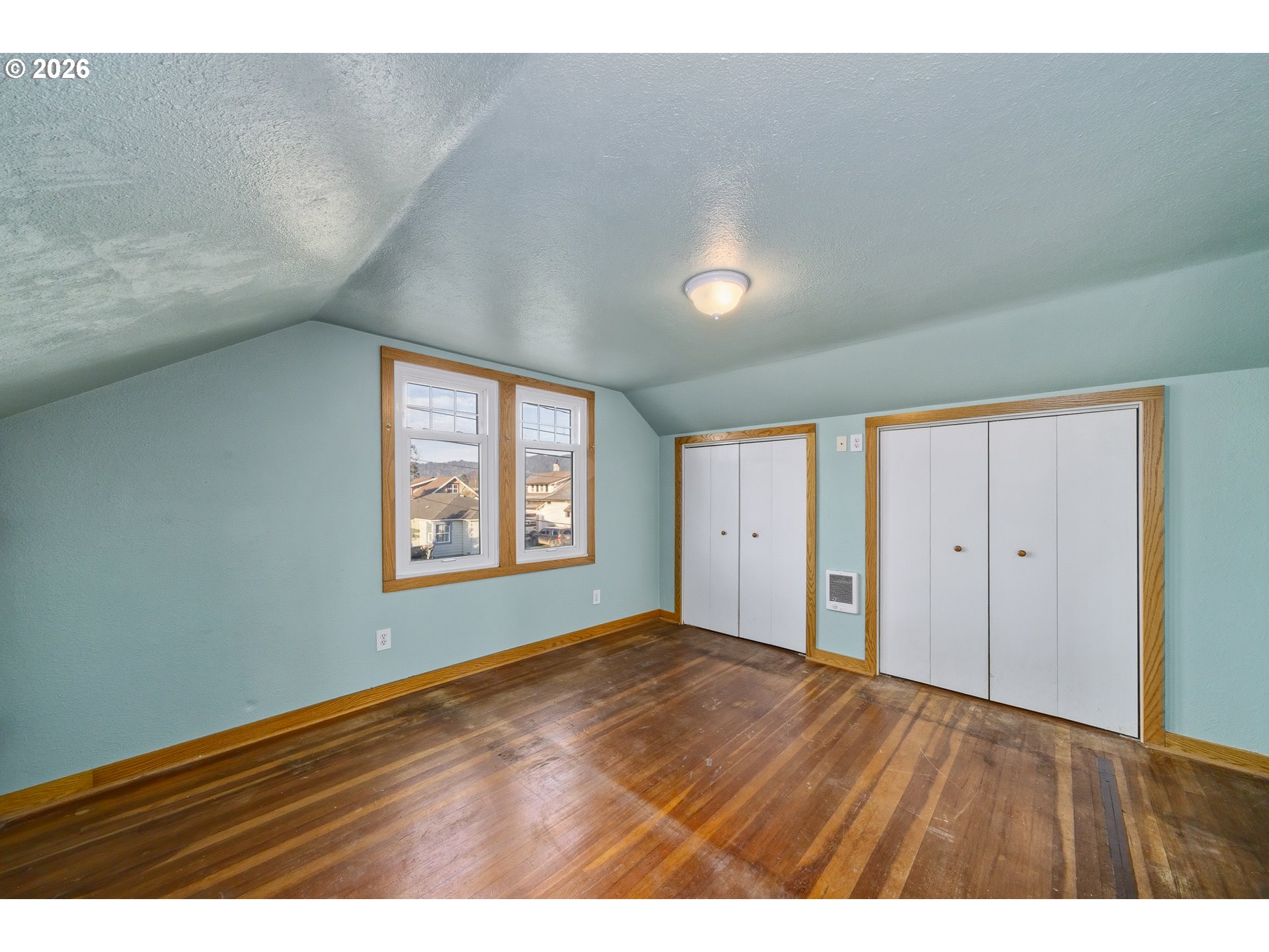 2507 6th Street Tillamook, OR 97141 - Photo 28 of 45 a view of an empty room with wooden floor and a window