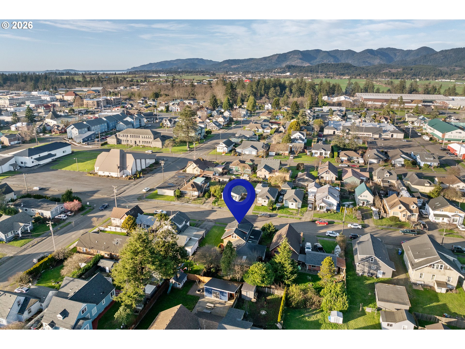 2507 6th Street Tillamook, OR 97141 - Photo 42 of 45 a view of a city with mountains in the background