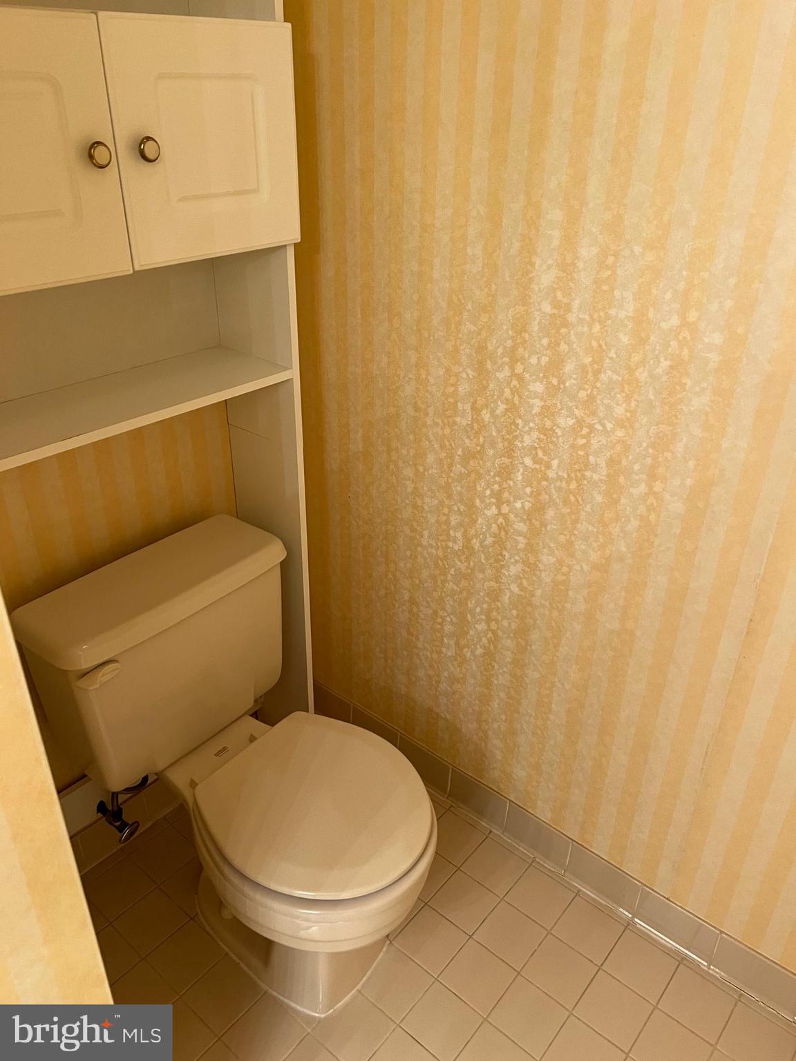 10775 Brewer House Road Rockville, MD 20852 - Photo 11 of 19 a white toilet sitting next to a shower curtain